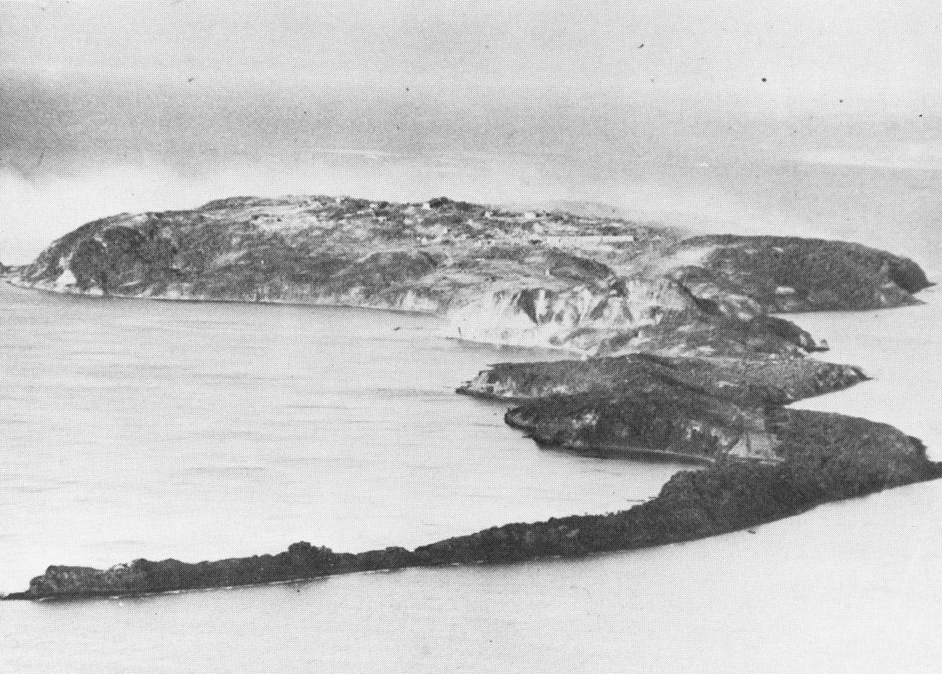 An aerial photograph of the rocky island of Corregidor, home to the underground headquarters of Fort Mills. This view looking west shows the narrow peninsula on which Japanese invasion forces landed. (U.S. Army photograph) An aerial photograph of the rocky island of Corregidor, home to the underground headquarters of Fort Mills. This view looking west shows the narrow peninsula on which Japanese invasion forces landed. (U.S. Army photograph)